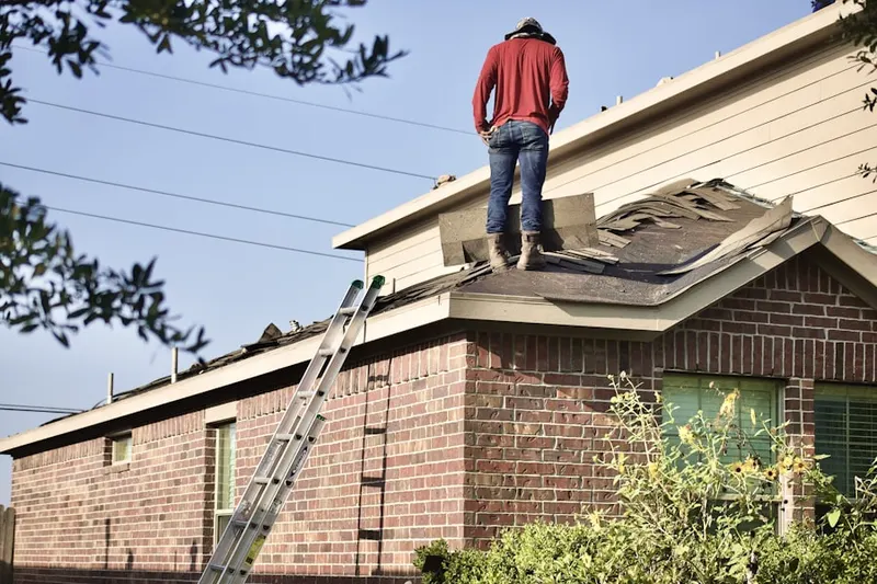 Professional roofer working on a residential roof in Wood Valley